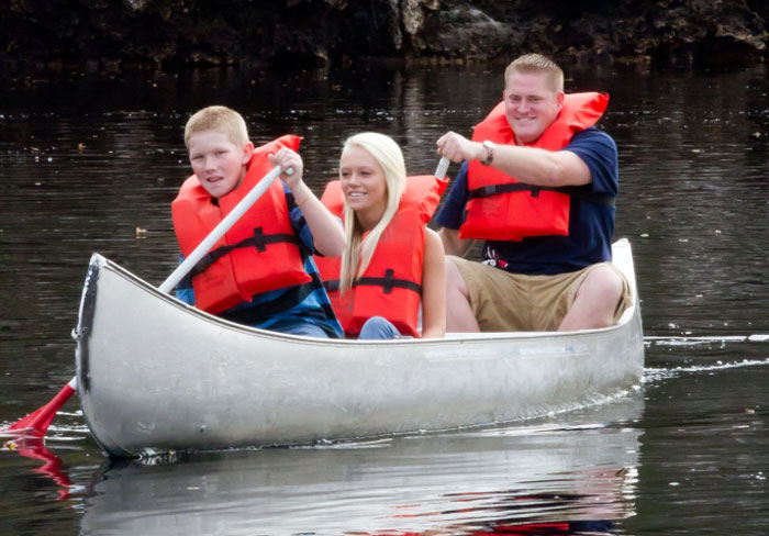 family canoeing on the lake