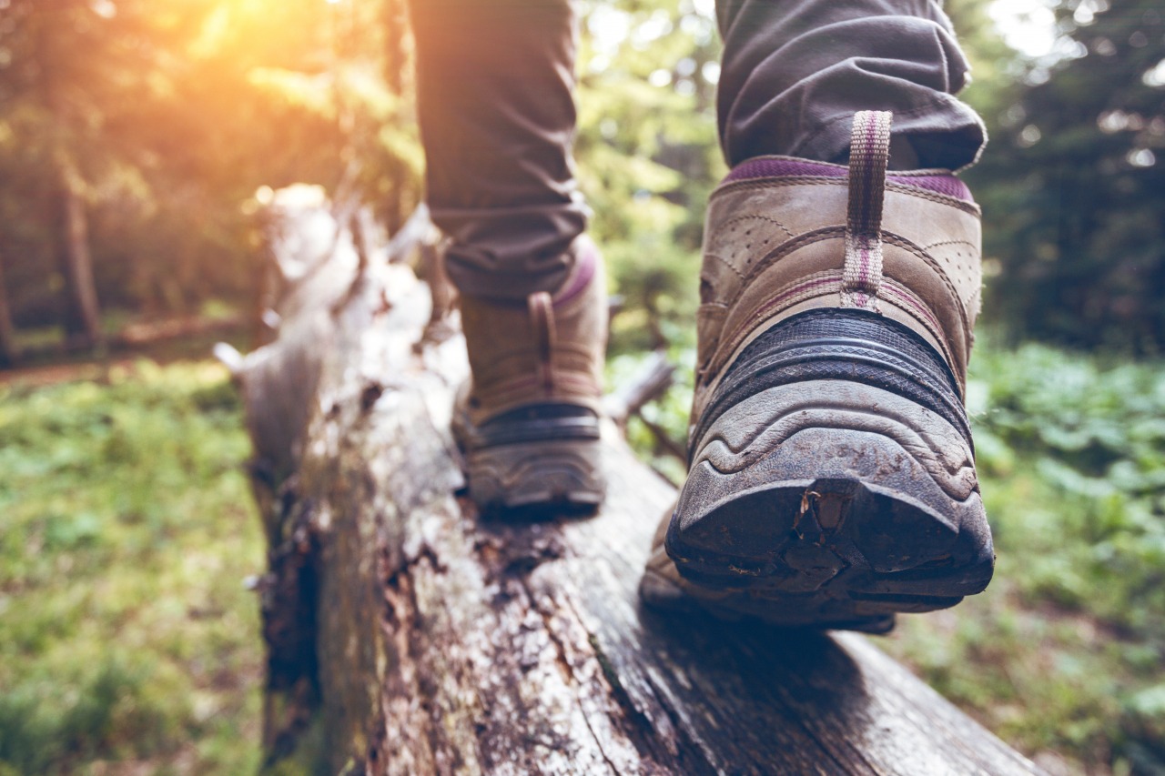 hiking boots on log