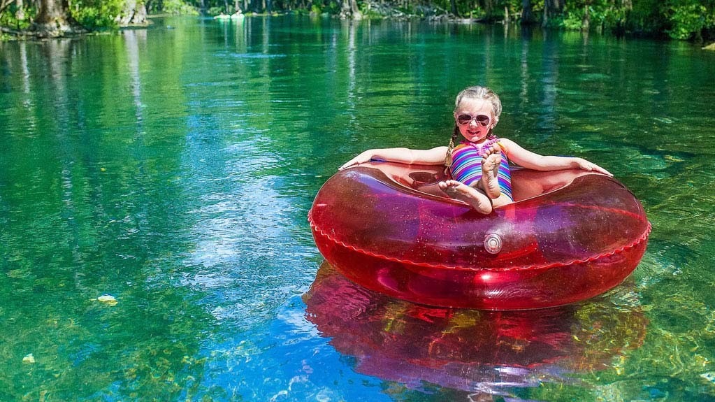 child tubing on the river